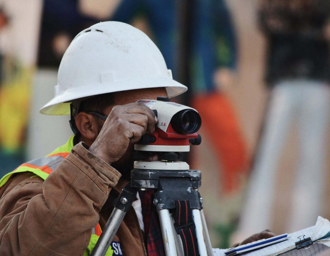 Site surveyor looking through camera